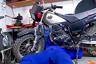 She helps the mechanic giving a blow job