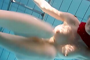 Redhead Mia stripping underwater